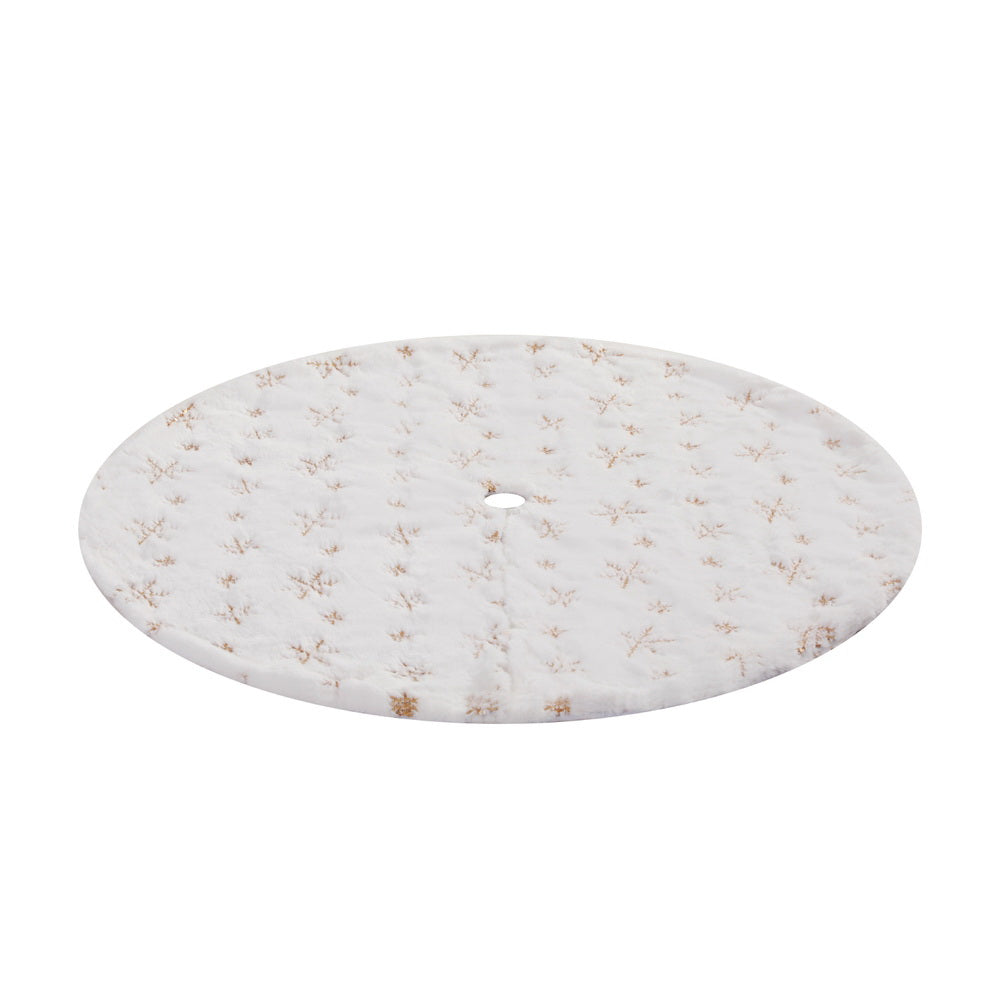 Christmas tree skirt with white fabric and gold snowflake pattern, center hole