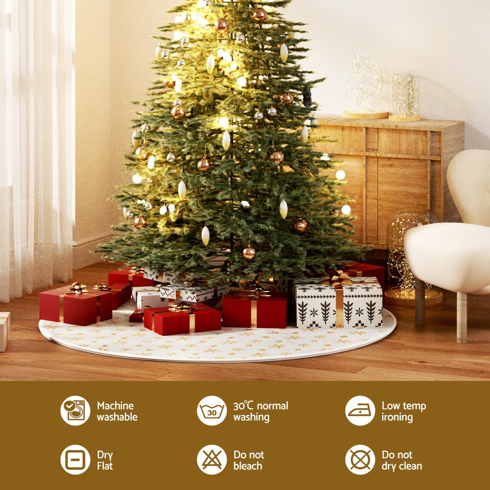 White Christmas tree skirt with repeating gold snowflake pattern and center opening