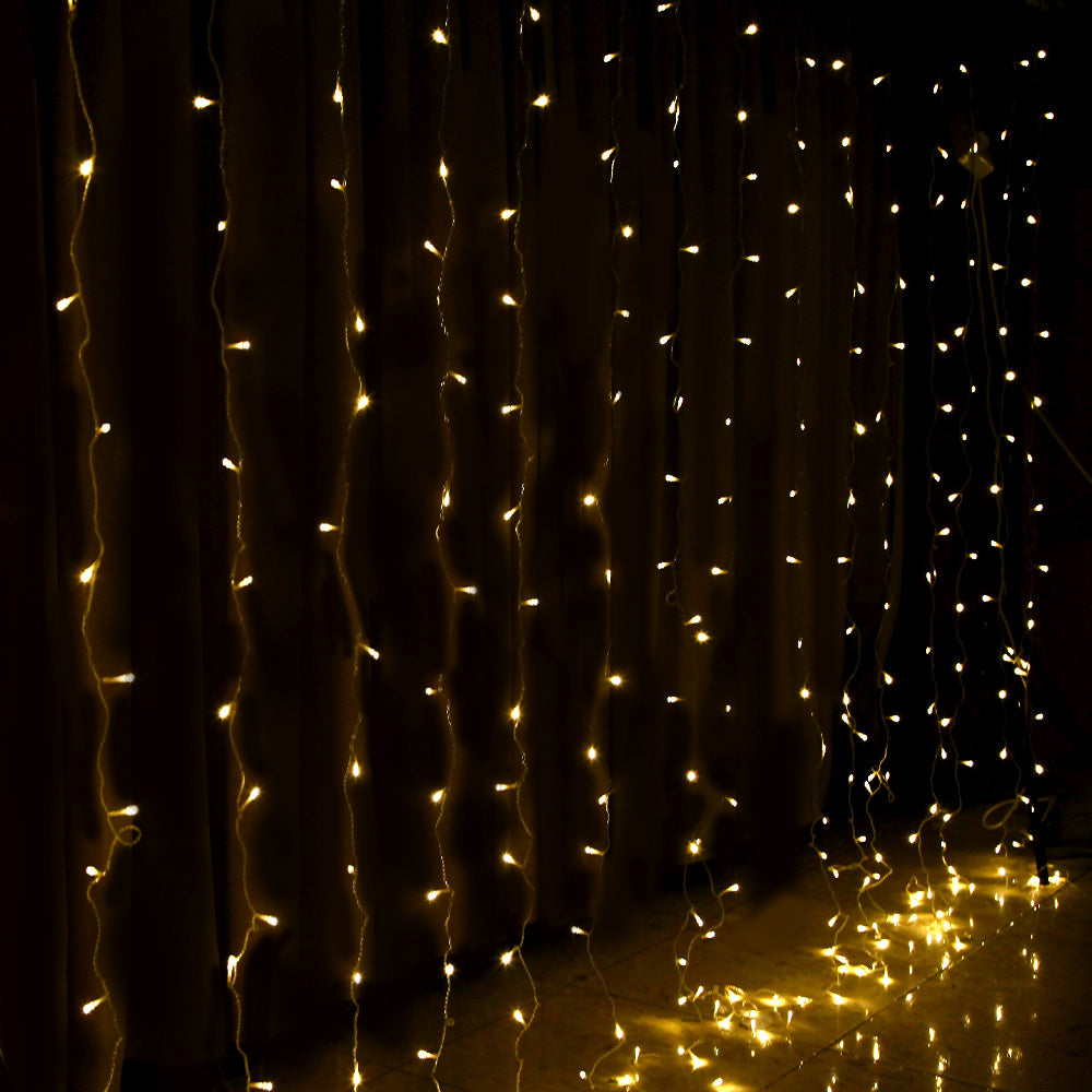 Warm white LED curtain lights with vertical hanging strands and glowing bulbs
