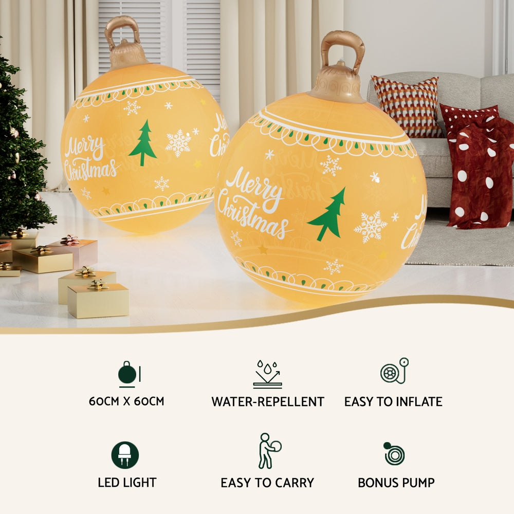 Pair of yellow Christmas inflatable LED balls with Merry Christmas and tree graphics