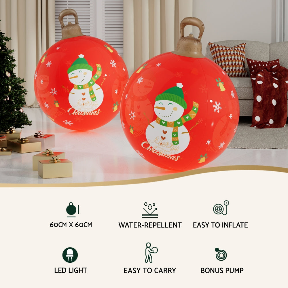 Pair of orange inflatable Christmas balls with LED snowman graphics and carry handles