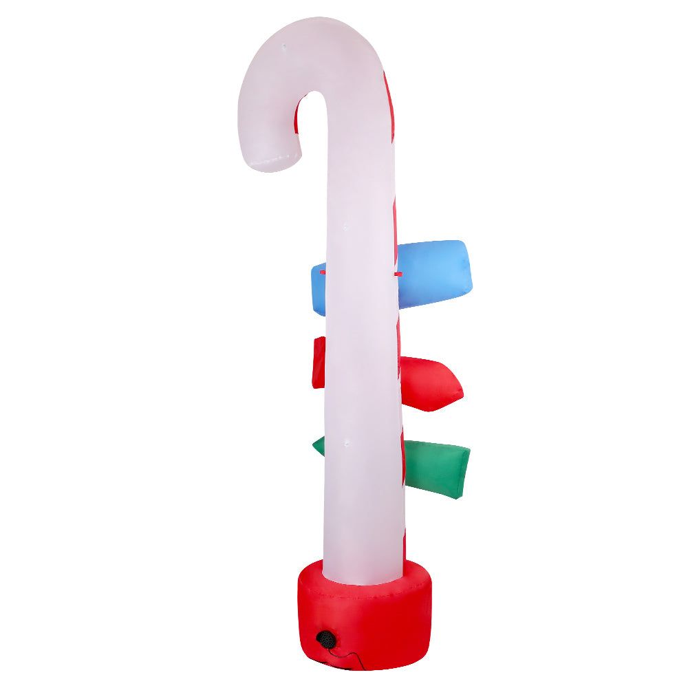 Inflatable candy cane pole with red base and colorful banner signs, partial view.