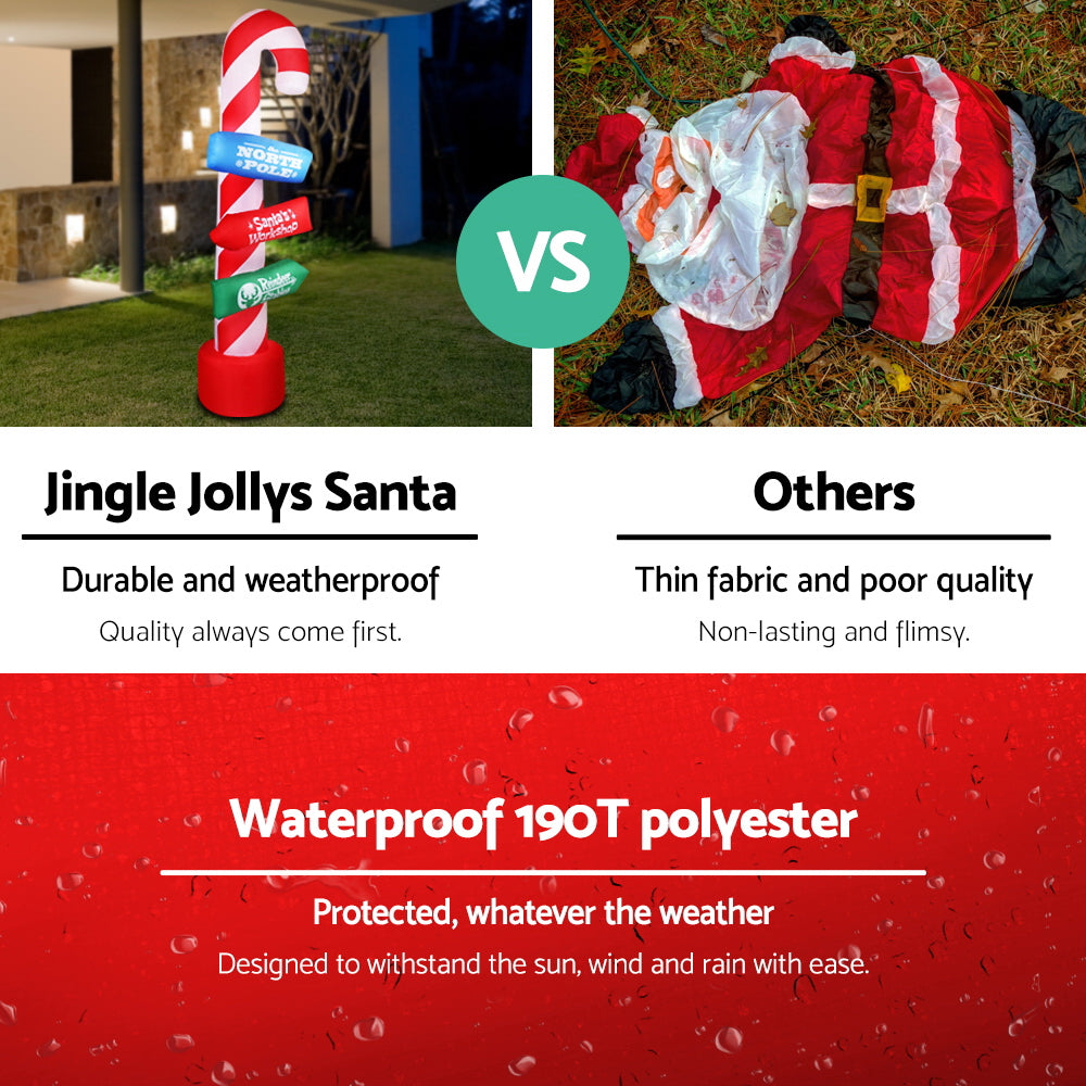 Inflatable candy cane pole with lit sign panels and red base, shown outdoors.