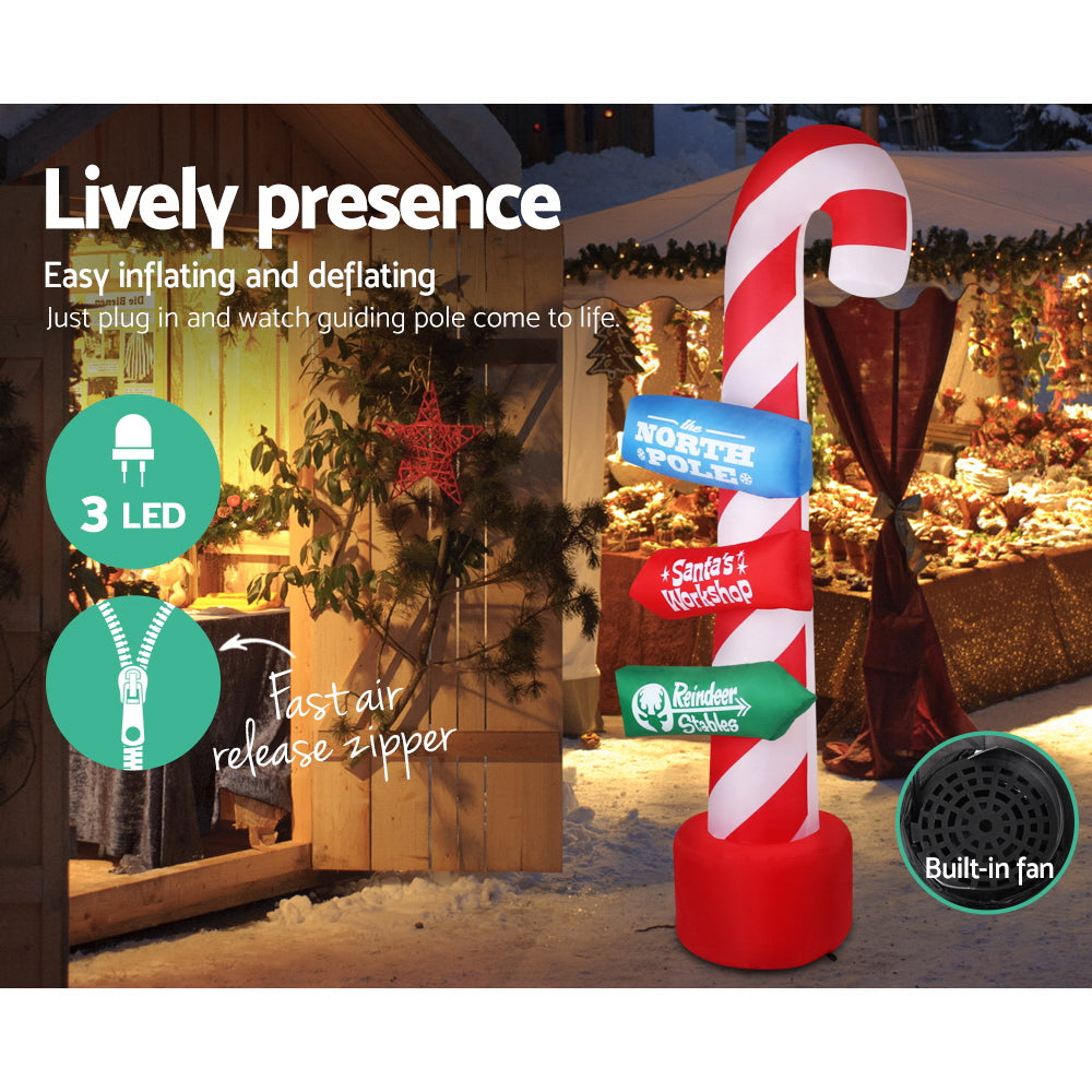 Inflatable candy cane pole with 3 LED lights, lit sign panels, red base, built-in fan.