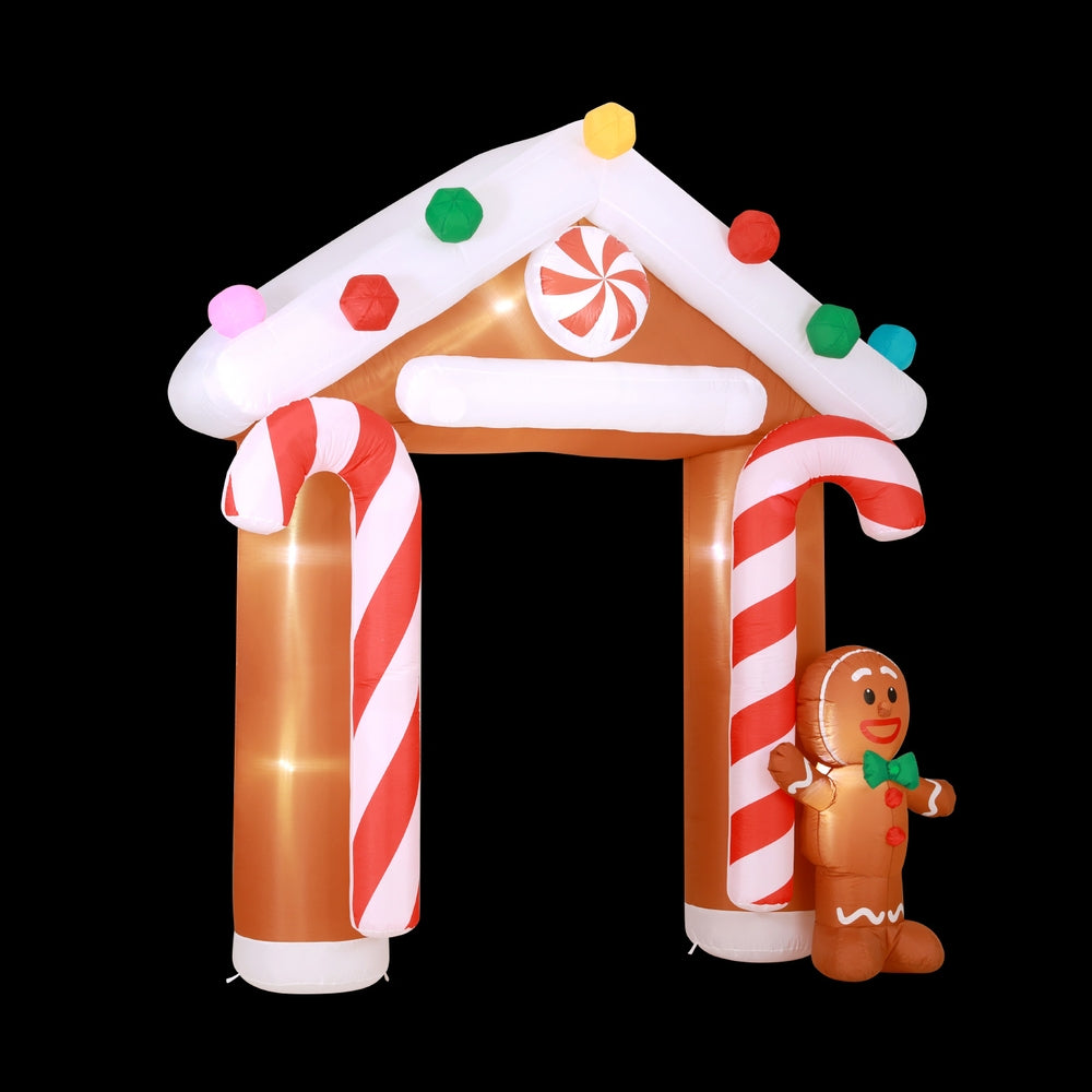 Inflatable Christmas arch with lit gingerbread figure, candy-cane pillars and roof lights