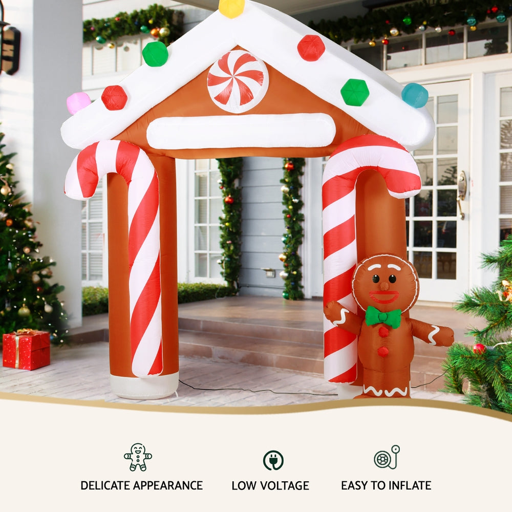 Inflatable Christmas arch with gingerbread figure accessory and candy-cane entrance sides