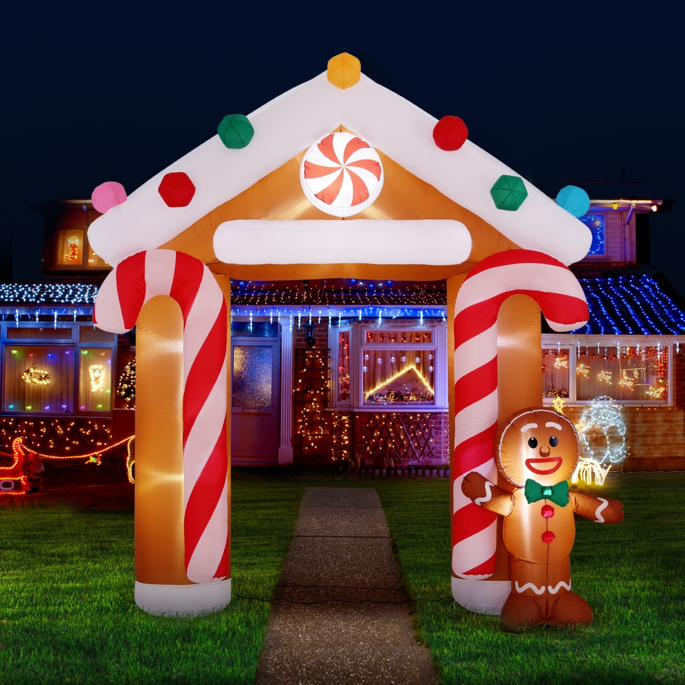 Inflatable Christmas arch with glowing interior, gingerbread character and multicolor roof lights