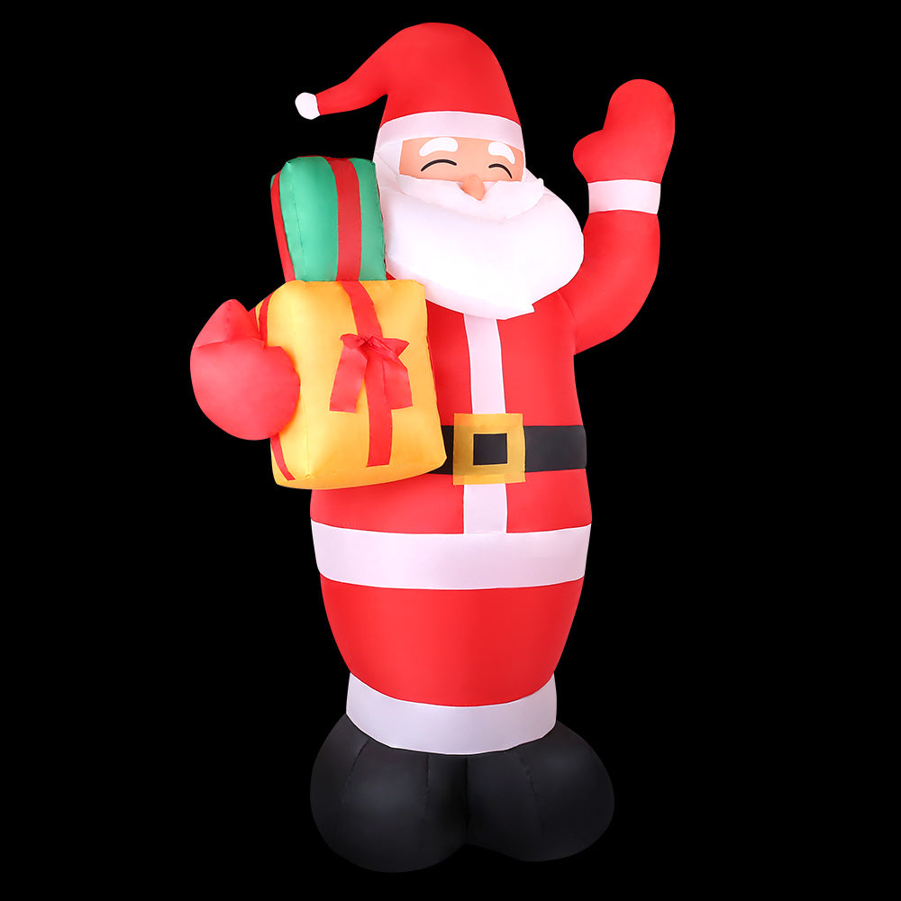 Inflatable Santa decoration with red-and-white striped suit, holding a green gift and waving