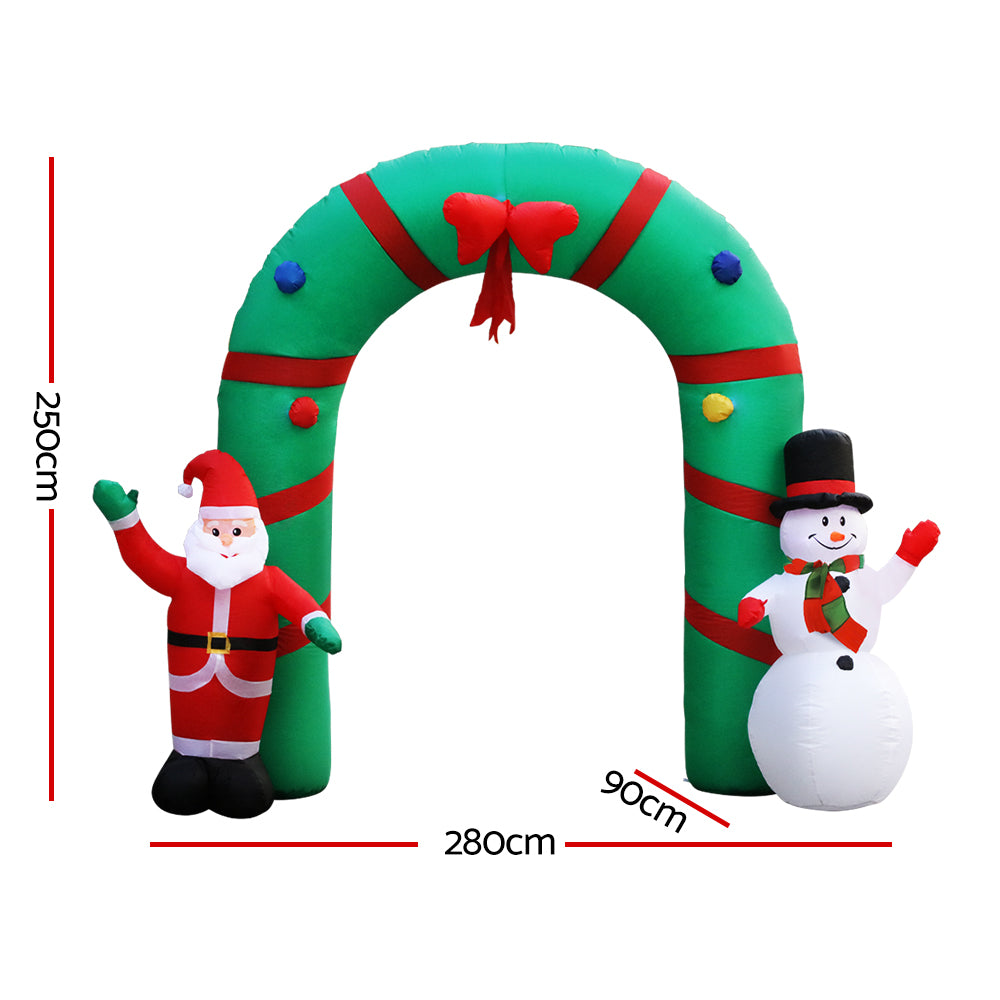 Inflatable Christmas archway with red elf and white snowman, shown with size markings
