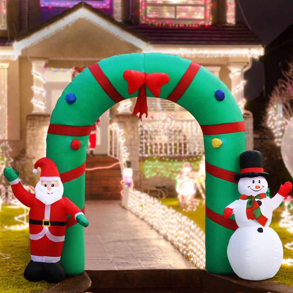 Inflatable Christmas archway with red elf and white snowman, arched opening and bow topper