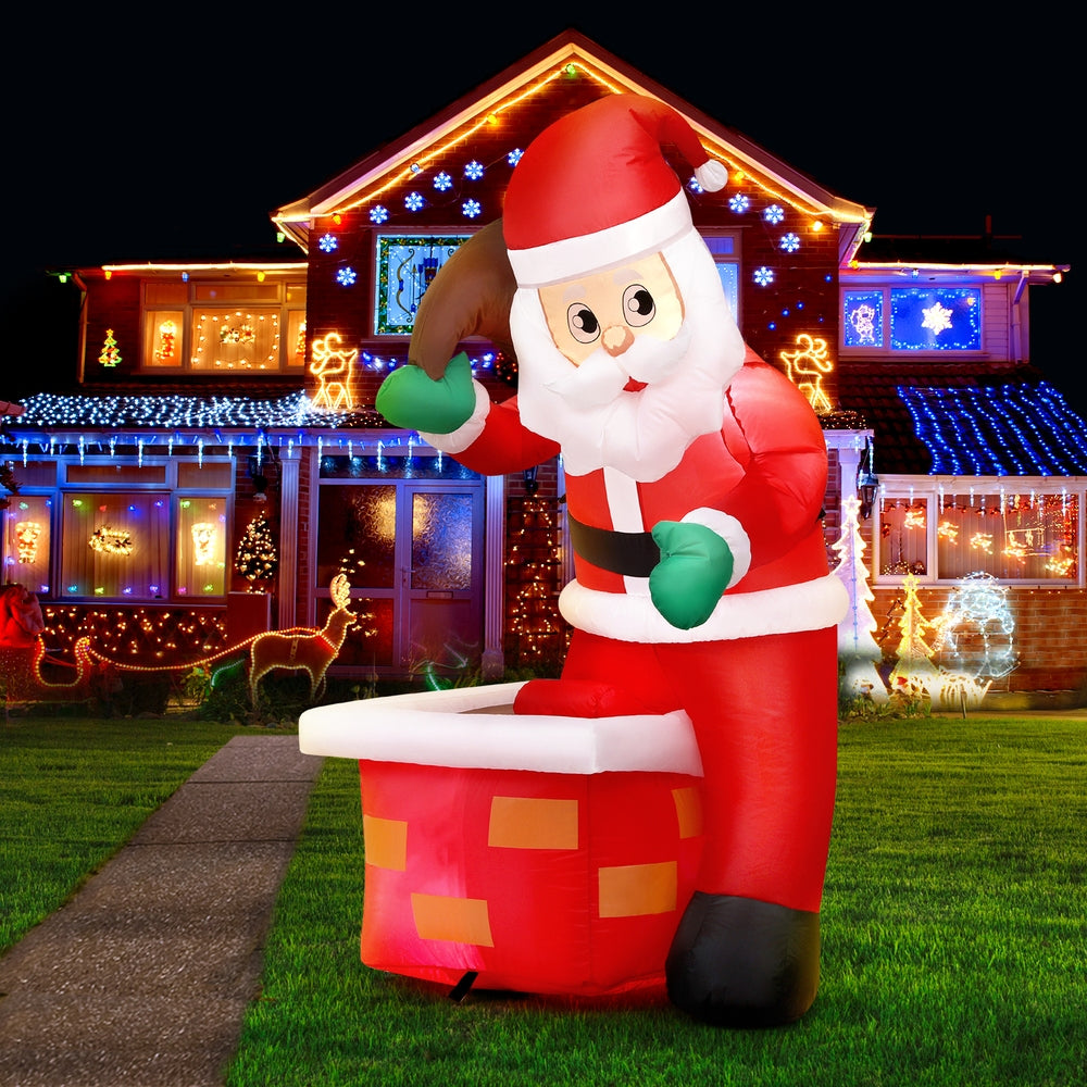 Inflatable Santa yard decoration lit with multi-color LEDs, red suit, white beard, and gift box