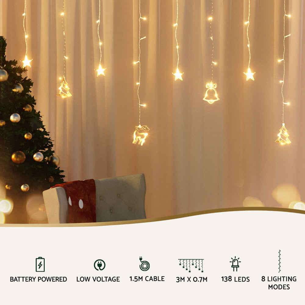 Warm white LED icicle lights draped beside a Christmas garland and pillows