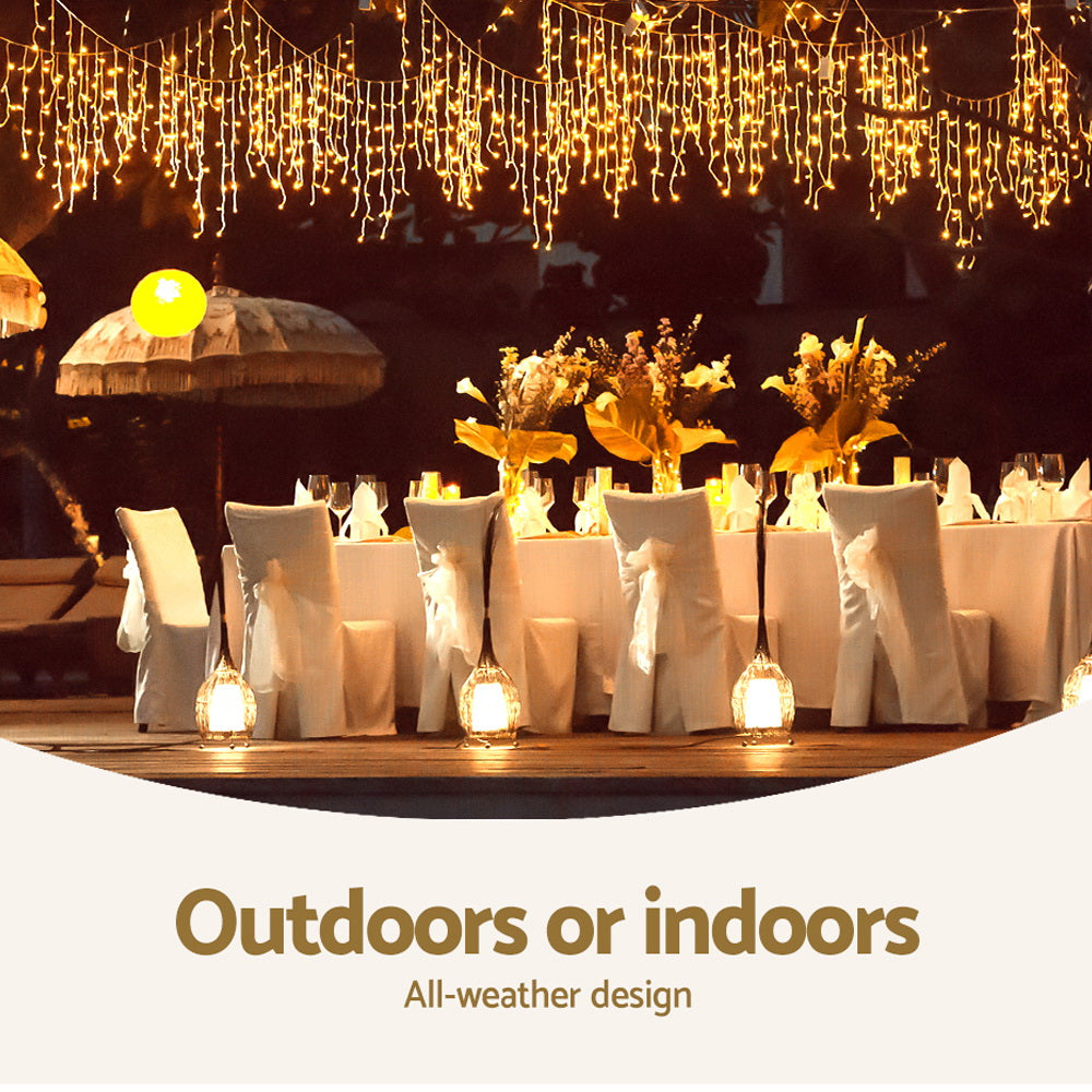 Warm white icicle string lights hanging above seated outdoor event décor