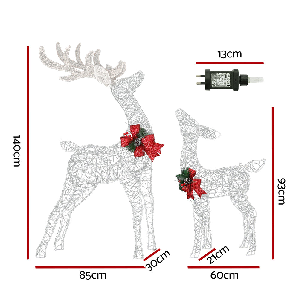 Wire reindeer light decorations with red bow accents, two standing figures