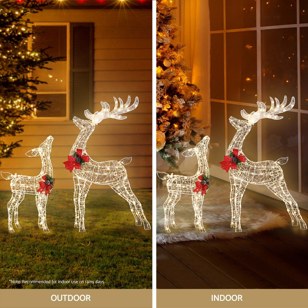 Glowing wire reindeer LED decorations with red bows, two standing figures