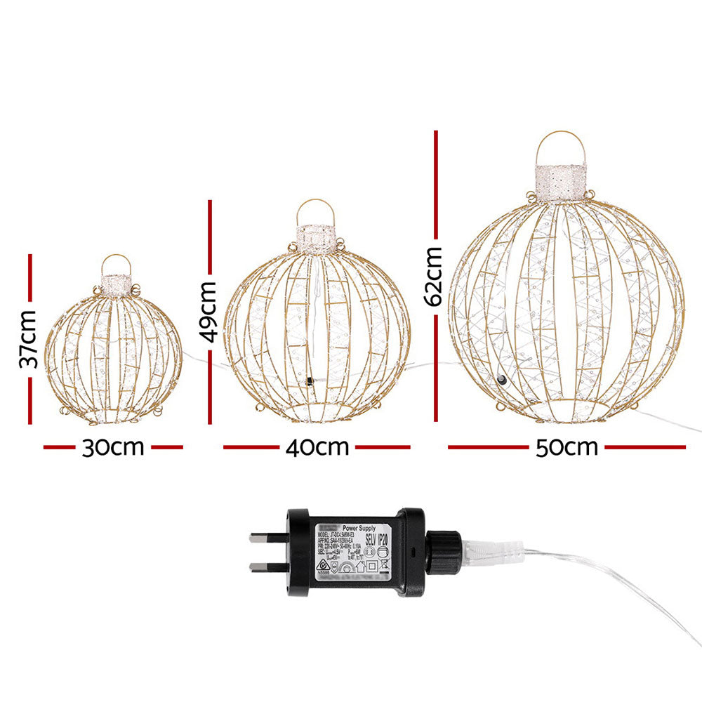 Three gold wire LED ball ornaments with hanging handles and attached power plug