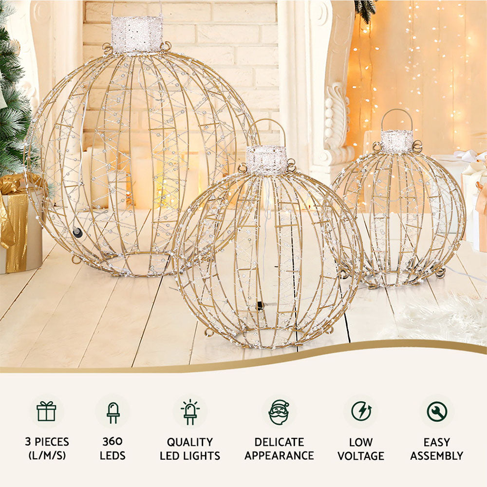 Set of three gold wire hanging LED light ball ornaments with warm white glow