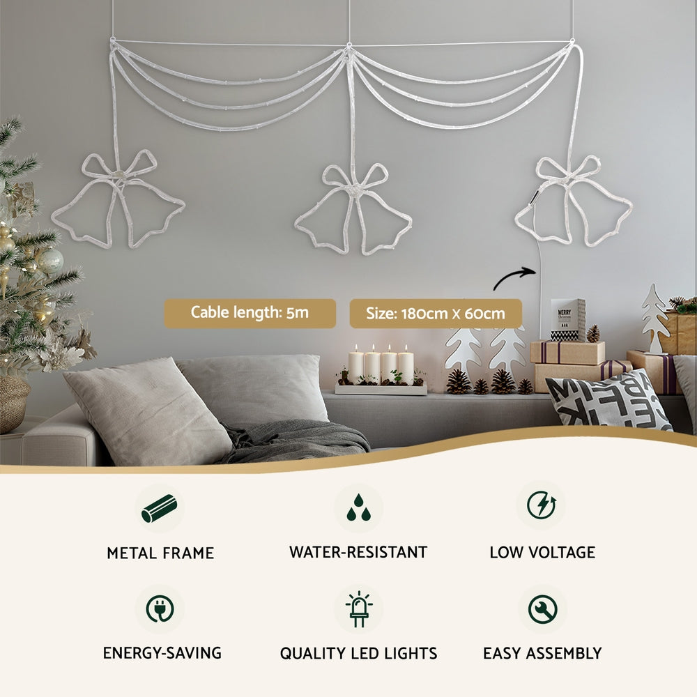 Christmas light curtain with three white bell bow LED motifs on a metal frame