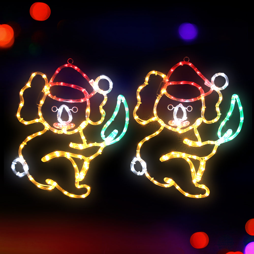 Two multicolor LED rope light angel motifs with red hats, gold glow, green accents, white bulbs