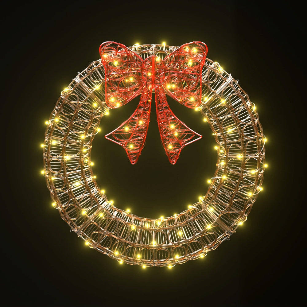 Solar LED wreath with gold metal ring, warm white lights, red ribbon bow
