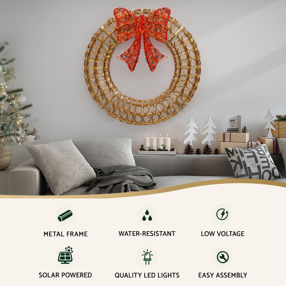 Solar LED wreath with gold wire ring and red bow