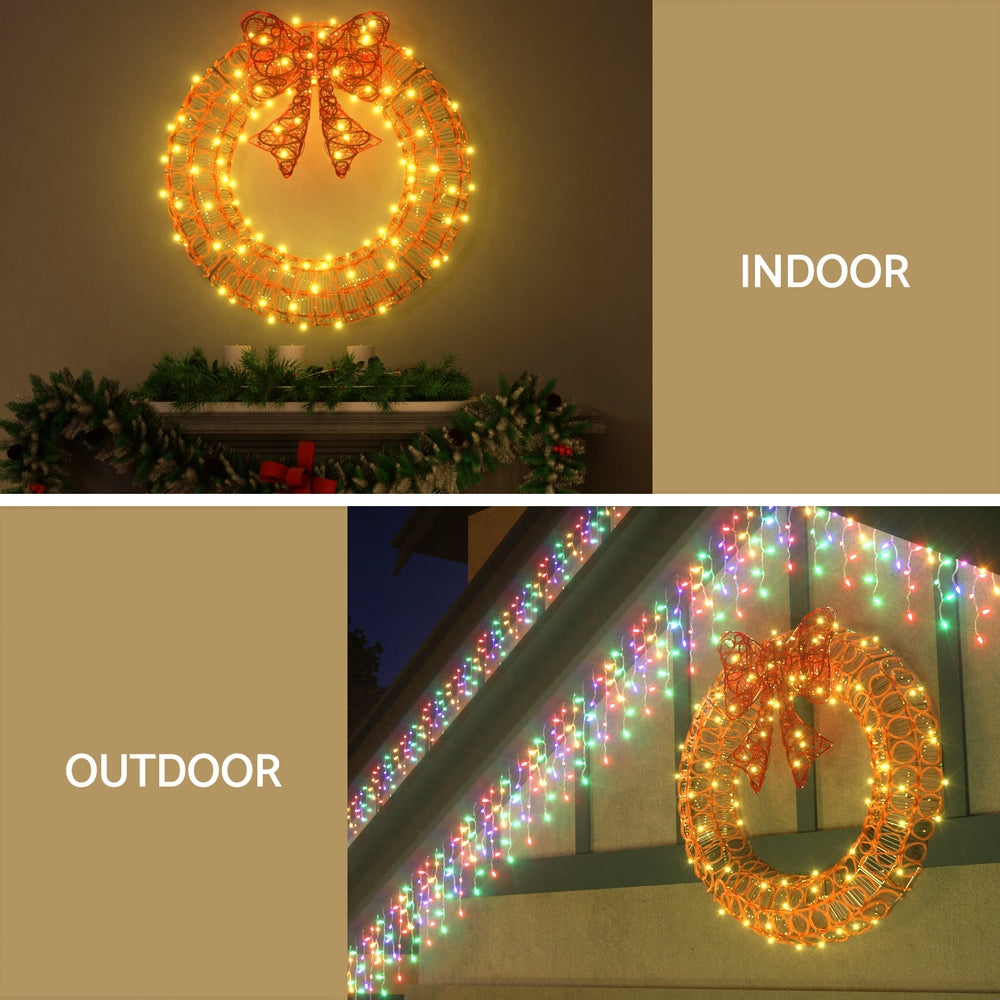Solar LED wreath with multicolor LED lights and red ribbon bow on gold wire ring