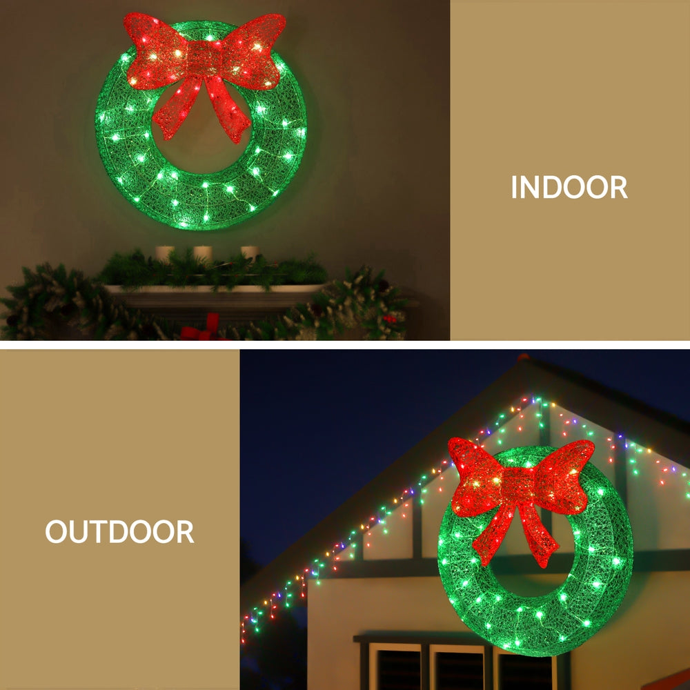 Solar wreath light decoration with red bow and green LEDs on green circular frame