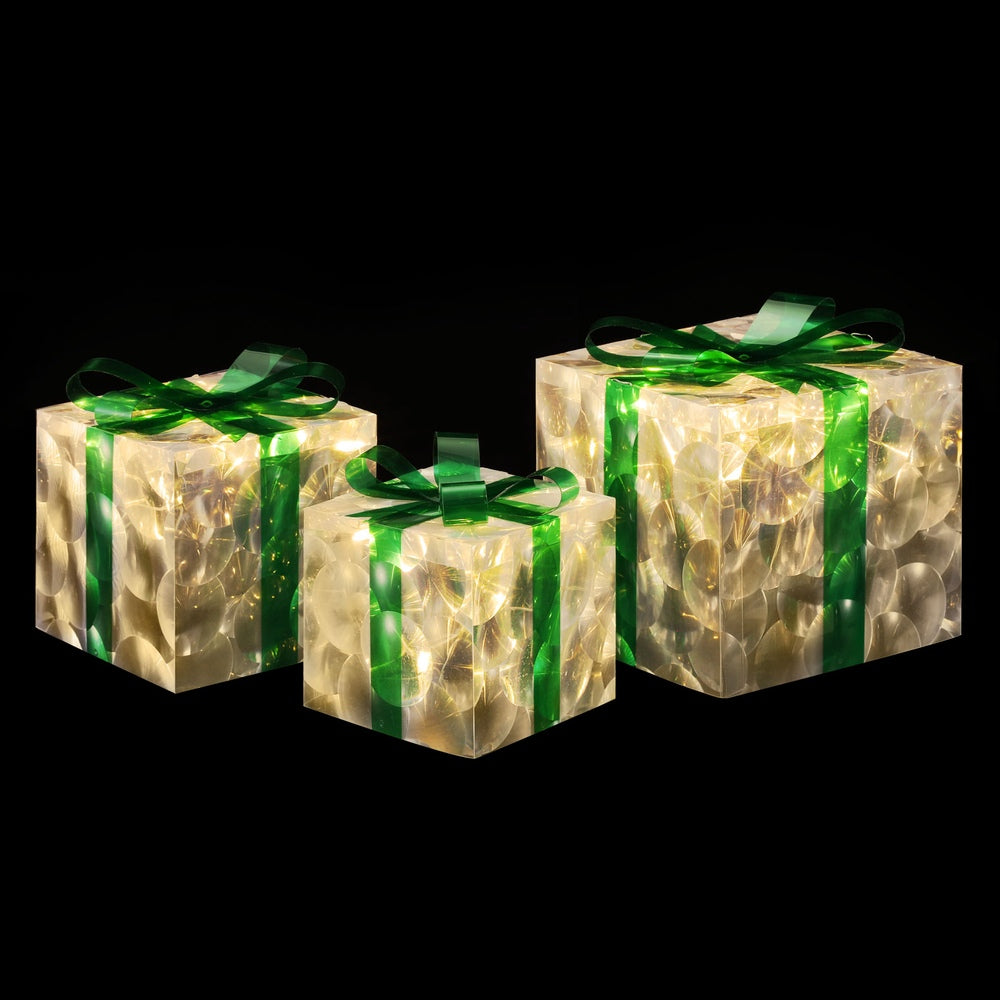 Set of 3 illuminated gift-box fairy lights with green ribbons, warm glow.