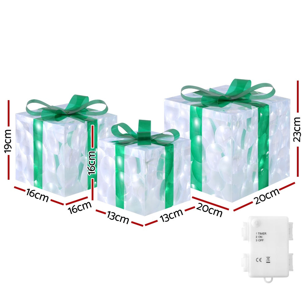 Three clear gift-box LED fairy lights with green bows and battery box/timer.
