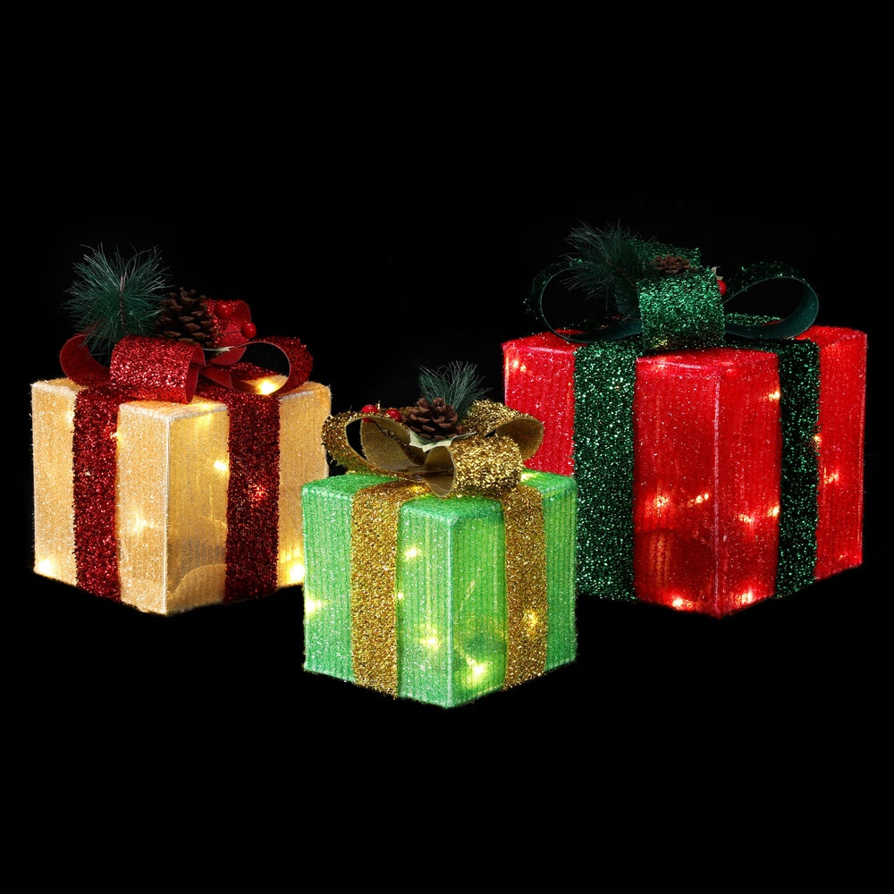 Gift box fairy lights with ribbon bows, warm glowing LEDs on three glittery gift boxes.