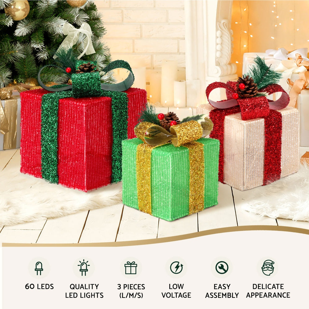 Set of illuminated fabric gift box fairy lights with ribbon bows in green, red, and white.