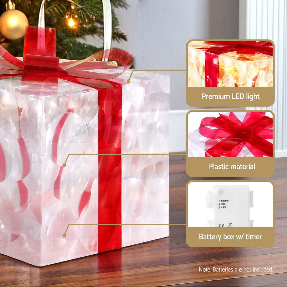 Close view of clear LED gift box with red bow; battery box with timer shown.