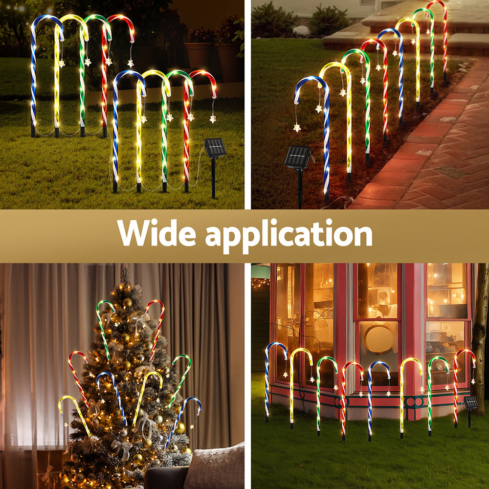 Eight multicolor LED solar path lights on a walkway, with spike stakes and solar panel