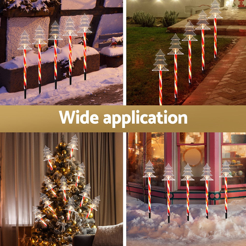Solar Christmas lights with tree LED heads on striped red-white stakes for outdoor decor