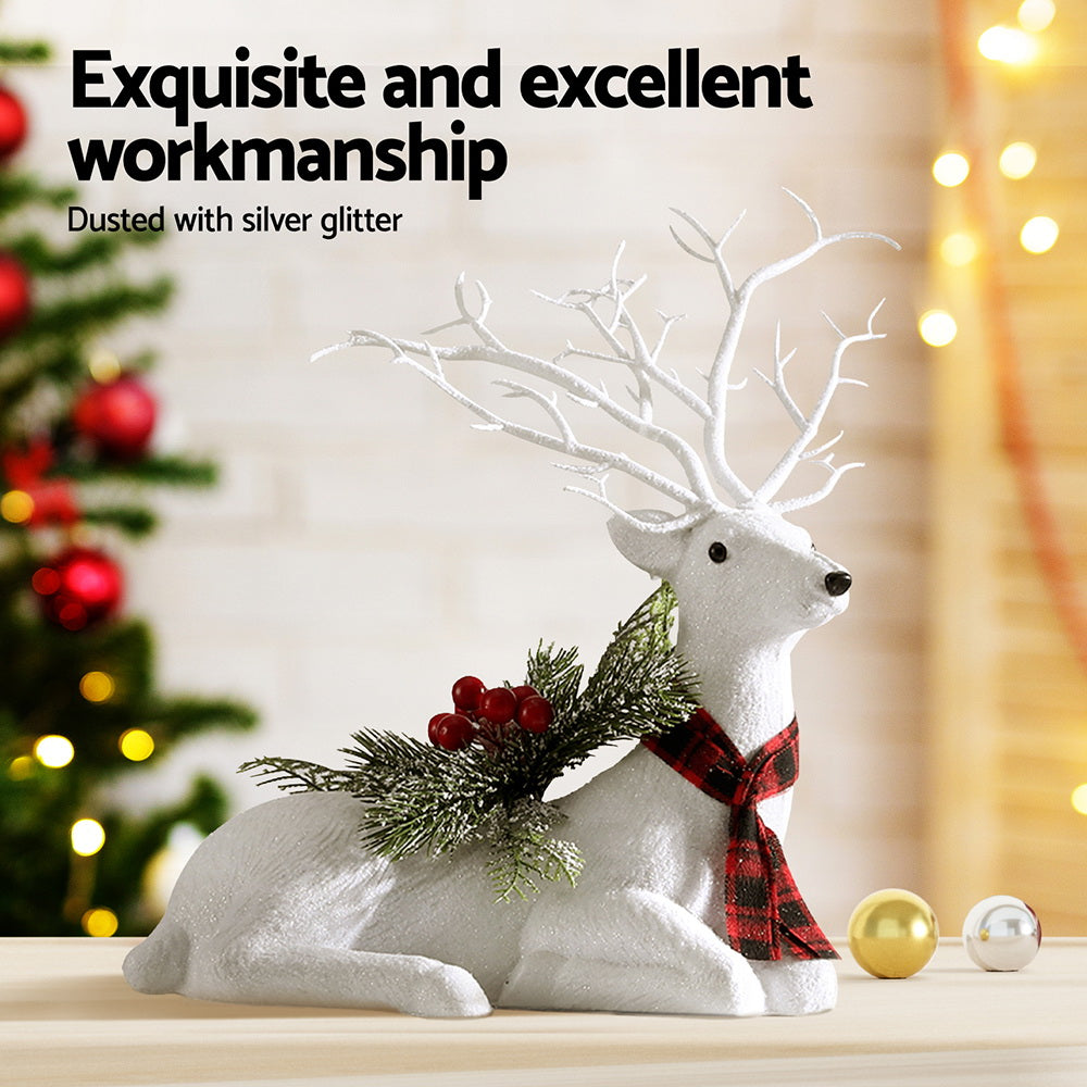 Christmas deer ornament, plush white reindeer with antlers, plaid scarf, pine sprigs and red berries; silver glitter.